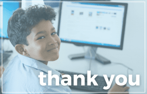 Thank you from PCs for People: image of a young boy sitting at a computer and smiling